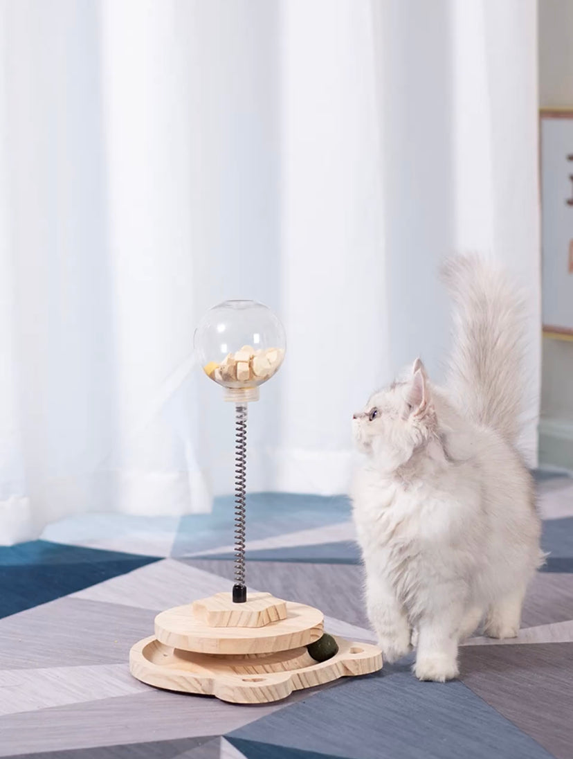 Treat dispensing spring-loaded cat toy