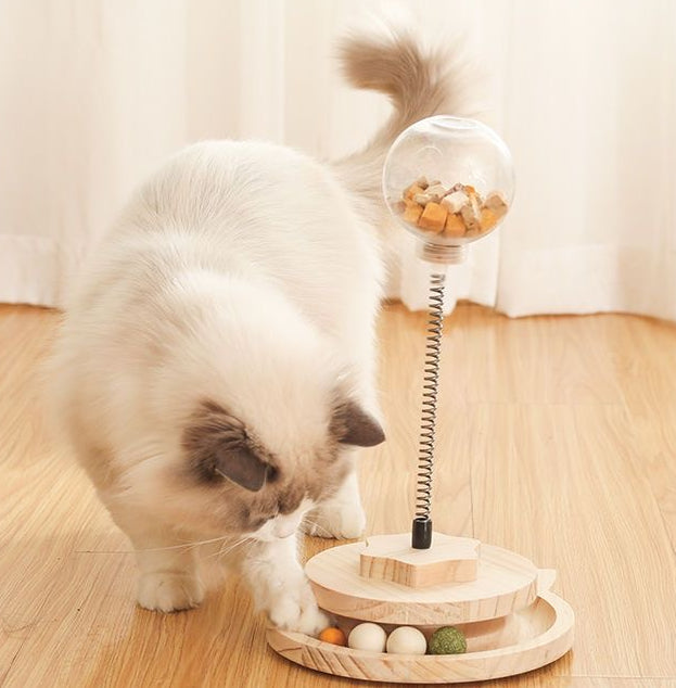 Treat dispensing spring-loaded cat toy